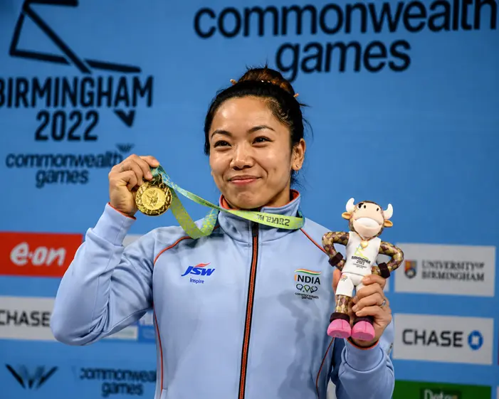 Mirabai Chanu Biography: Age, Height, Husband, Medals, Career & Net Worth (2026) Mirabai Chanu receiving Commonwealth Games gold medal